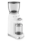 White Smeg retro line tritan renew coffee grinder with hopper on top and clear container with measurements for grounded coffee beans on a white background