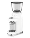 White Smeg retro line tritan renew coffee grinder with hopper on top and clear container with measurements for grounded coffee beans on a white background