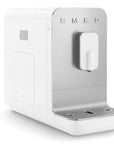 White and silver coffee machine with 'SMEG' branding on a white background