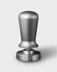 Stainless steel Smeg tamper on a white background