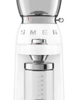 Front view of White Smeg retro line tritan renew coffee grinder with hopper on top and clear container with measurements for grounded coffee beans on a white background