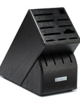 Black knife block with multiple slots on a white background