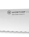 Knife with a black handle and visible Wusthof logo on a white background