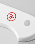 White handle of a knife with a red logo on a light gray background