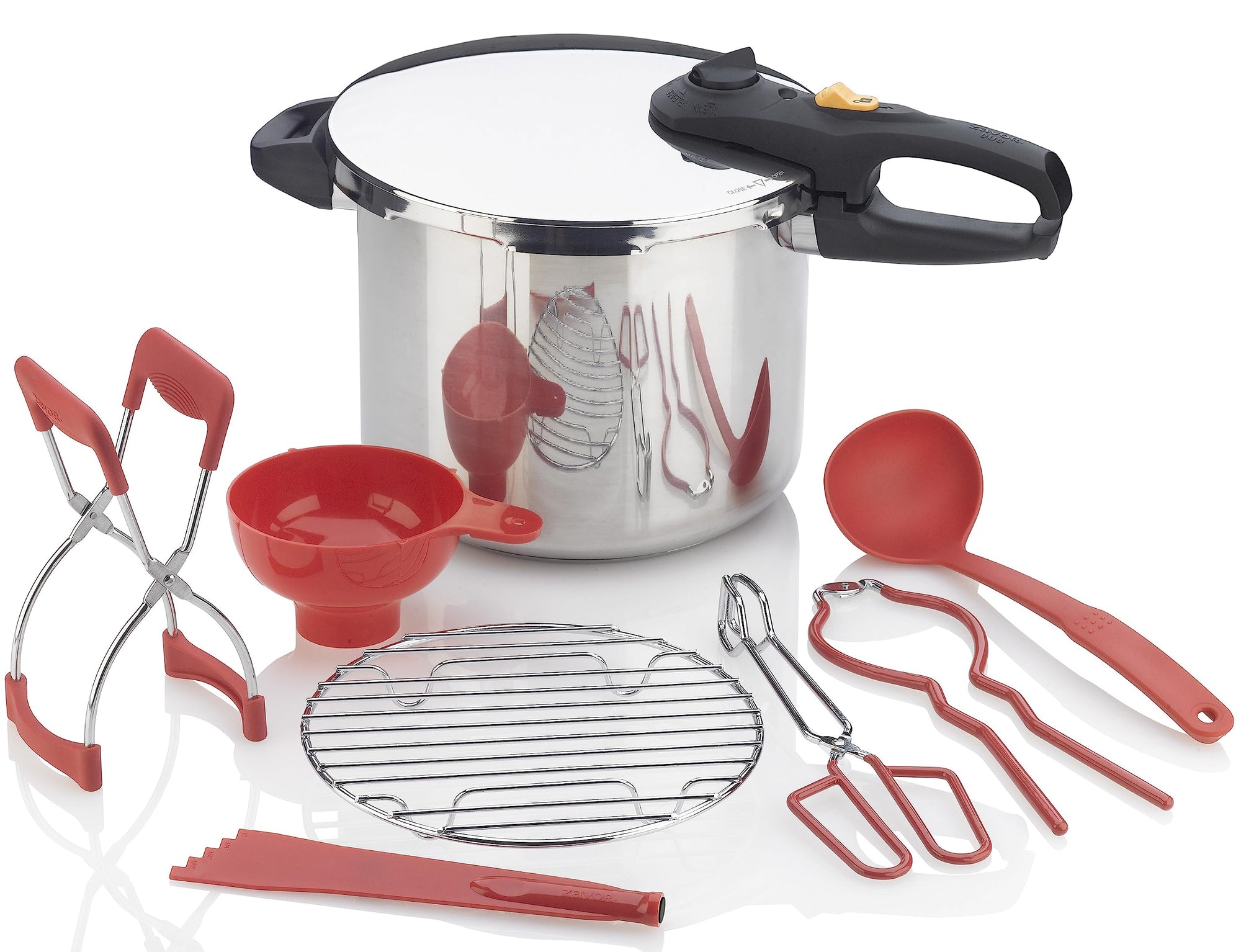A stainless steel pressure cooker canner set with various red accessories including tongs, a canning rack, and other cooking tools.