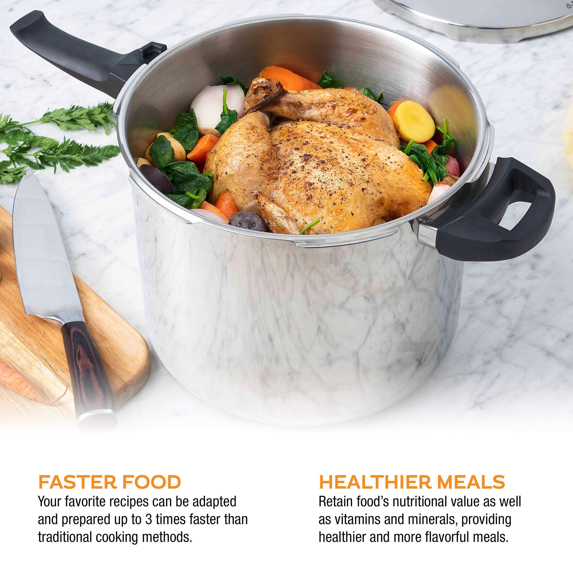Stainless steel pot with roasted chicken and vegetables on a marble surface