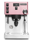Rancilio Silvia Pro X espresso machine in pink color, featuring a digital display, steam wand, and pressure gauge on the front panel.