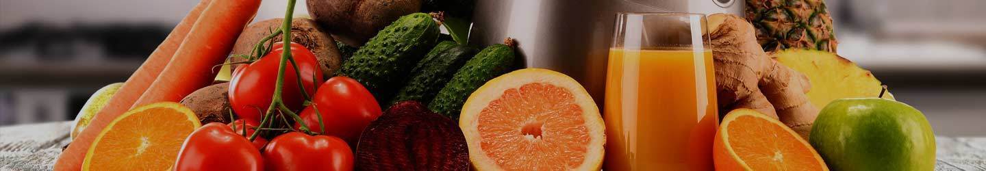 Various Fruits and Vegetables surrounding Kuvings Slow Juicer