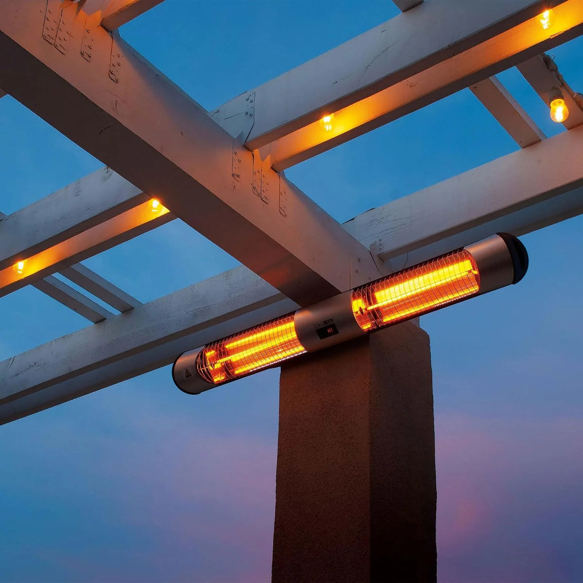 A cylindrical outdoor patio heater mounted on a pergola beam at dusk, glowing with bright orange heat waves against a blue twilight sky.