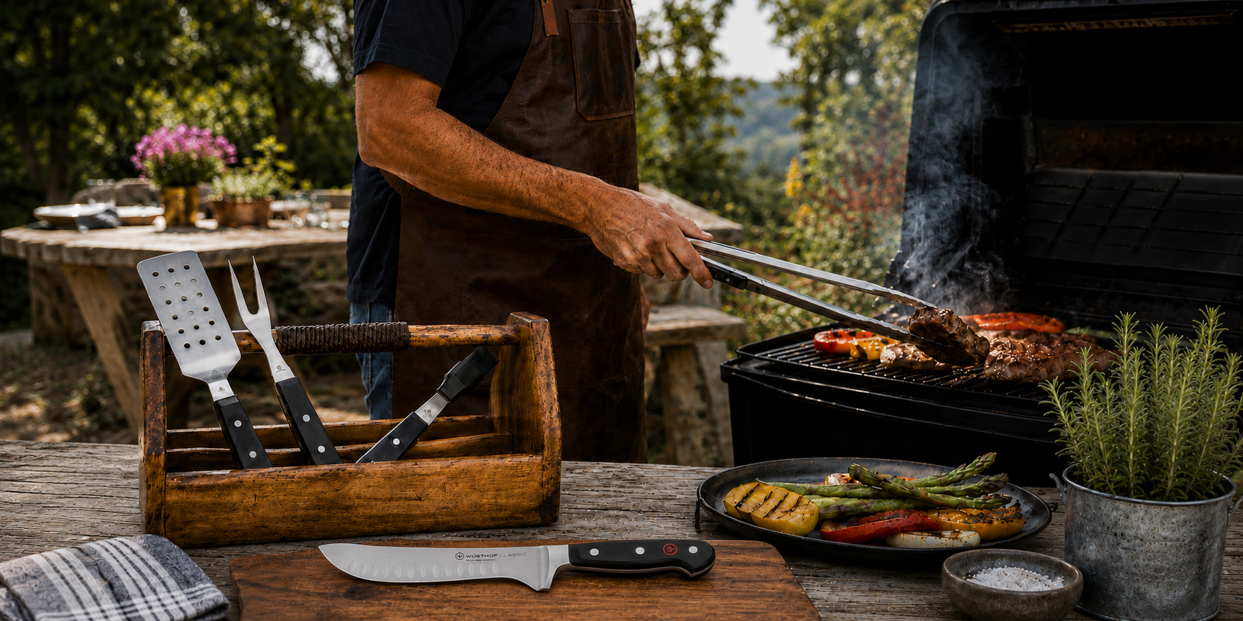 Person grilling outdoors with a wooden utensil holder and tools on a table.