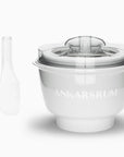 White ice cream maker with spatula displayed on a white background