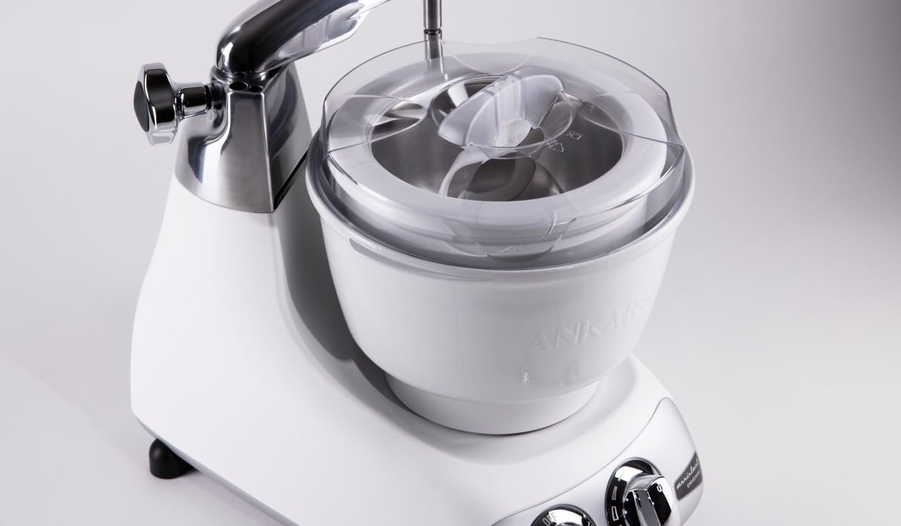 White ice cream maker with silver accents on a light gray background