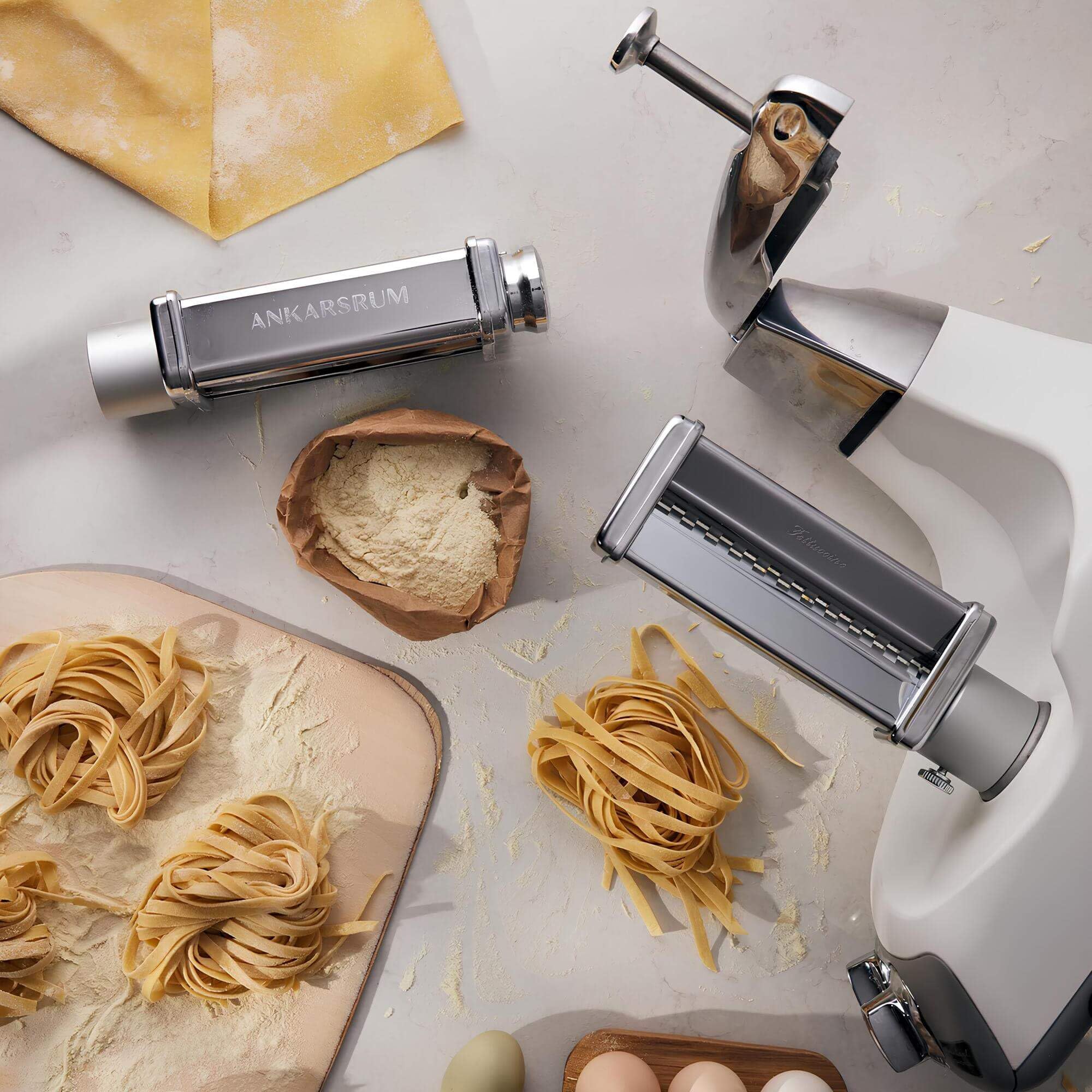 Pasta maker with pasta on a kitchen countertop