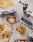 Pasta maker with pasta on a kitchen countertop