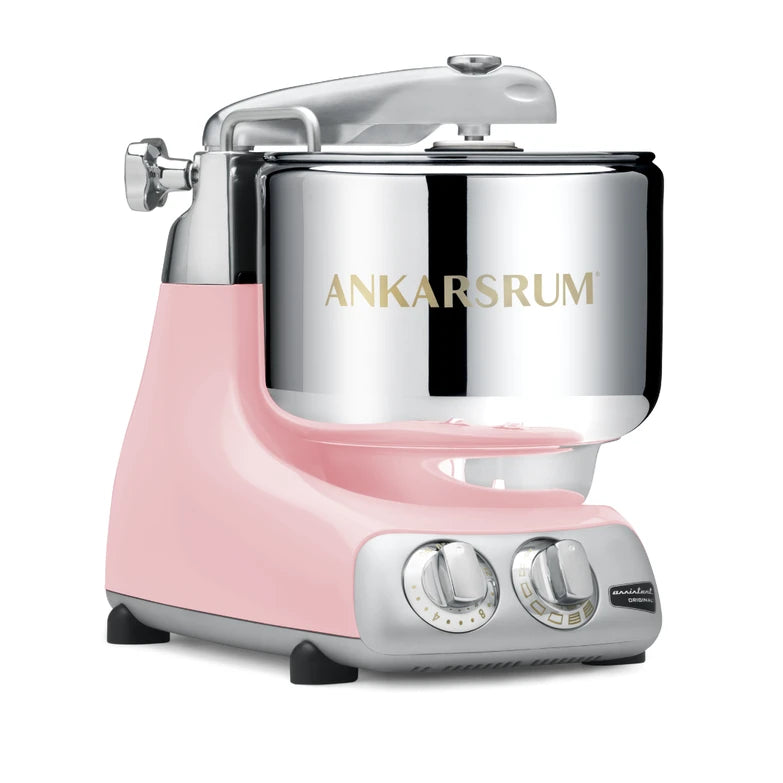 Cloudy pink kitchen stand mixer with silver bowl on a white background
