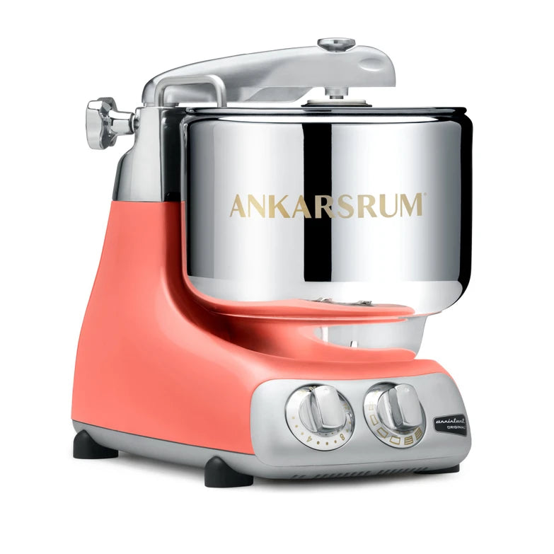 Coral crush kitchen stand mixer with silver bowl on a white background