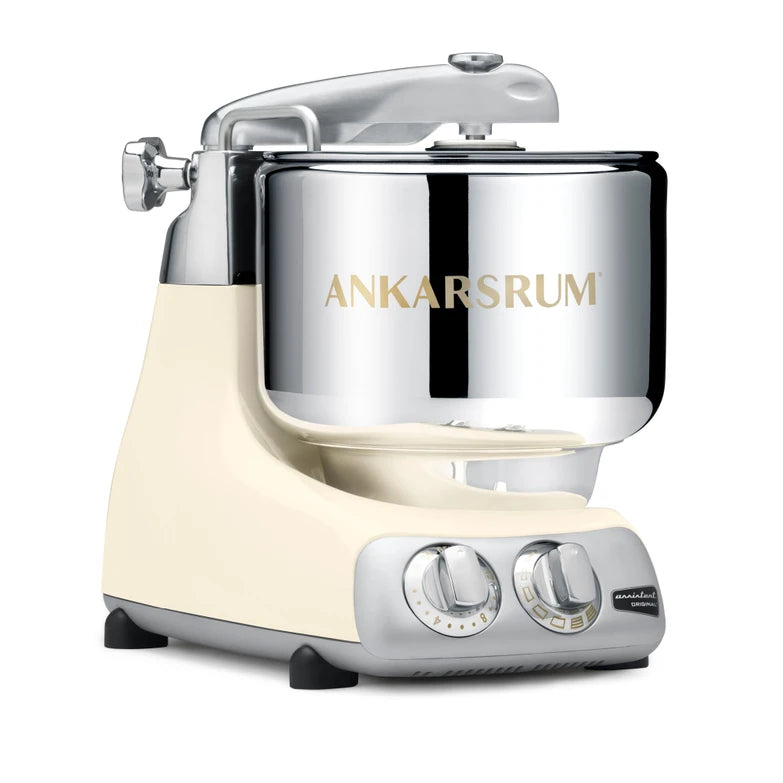 Ankarsrum stand mixer with light creme base and silver bowl on a white background