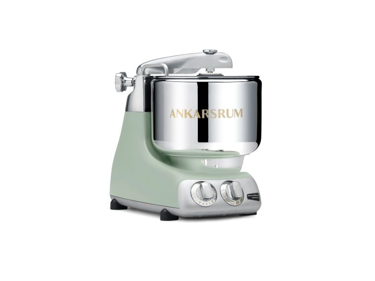 Green stand mixer with silver bowl on a white background