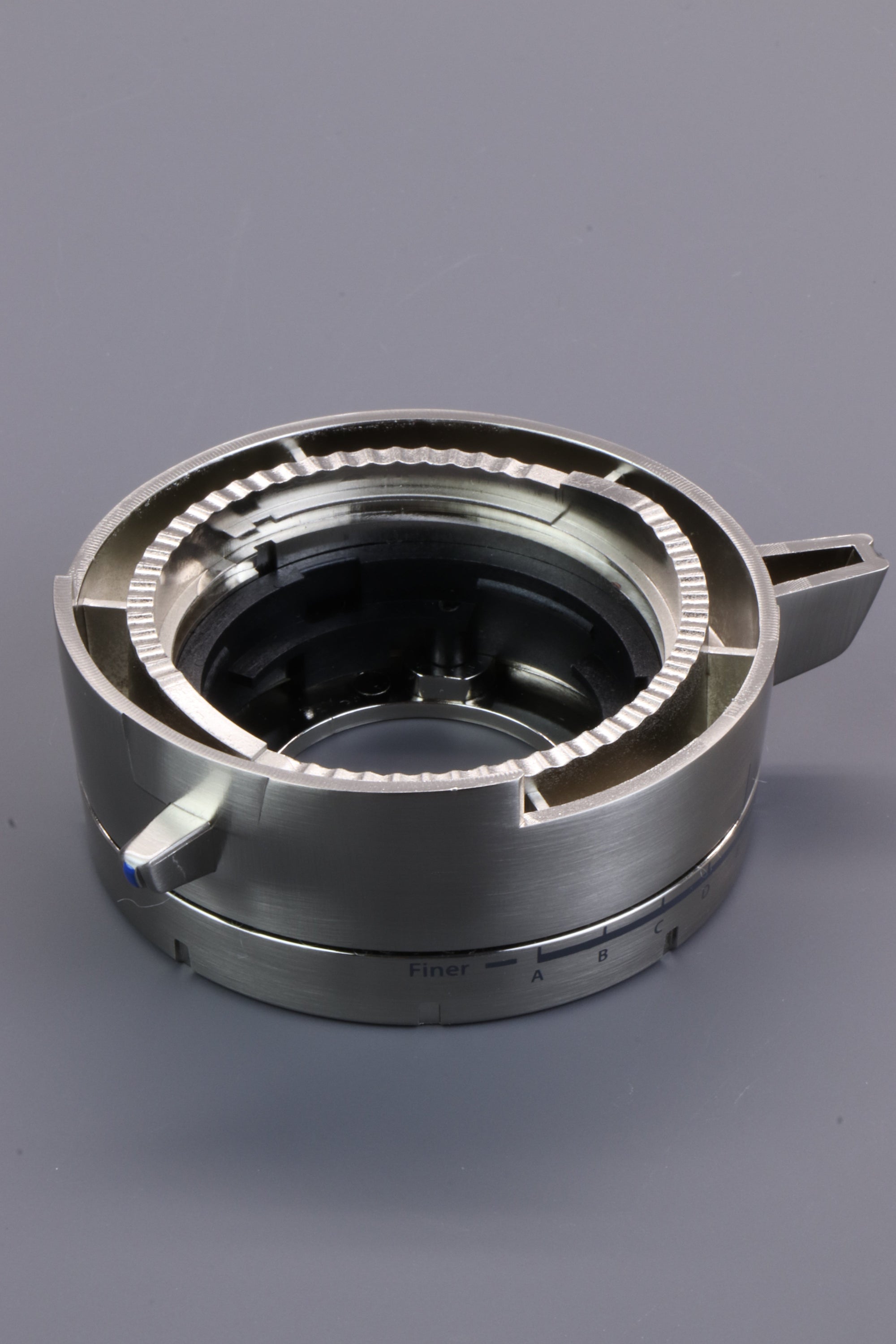 Gear for a coffee grinder displayed on a grey background