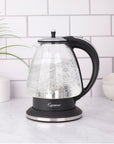 Black and polished chrome Capresso 48 oz electric kettle with water boiling on a kitchen counter