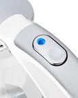 Close-up of a white electric kettle with a blue light indicator on a white background