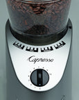 Close up of the dial on a Capresso coffee grinder with coffee beans inside on a gray background