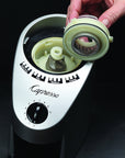 Capresso coffee grinder with a hand removing the blade on a black background