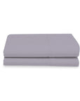 Folded light gray bed sheet on a white background
