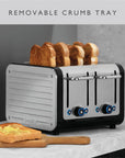 A four-slot toaster with a silver and black body, shown with four slices of toast popping out. A wooden cutting board with toast sits on a light stone countertop in front.