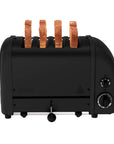 A black 4-slice toaster with four slices of toast emerging from the slots, shown from a front-facing angle on a plain white background.