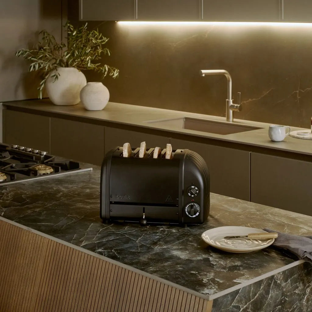 Black toaster on a kitchen counter with a modern kitchen background