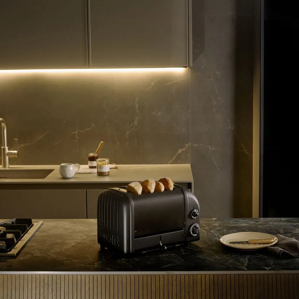 Modern toaster on a kitchen counter with a marble backsplash