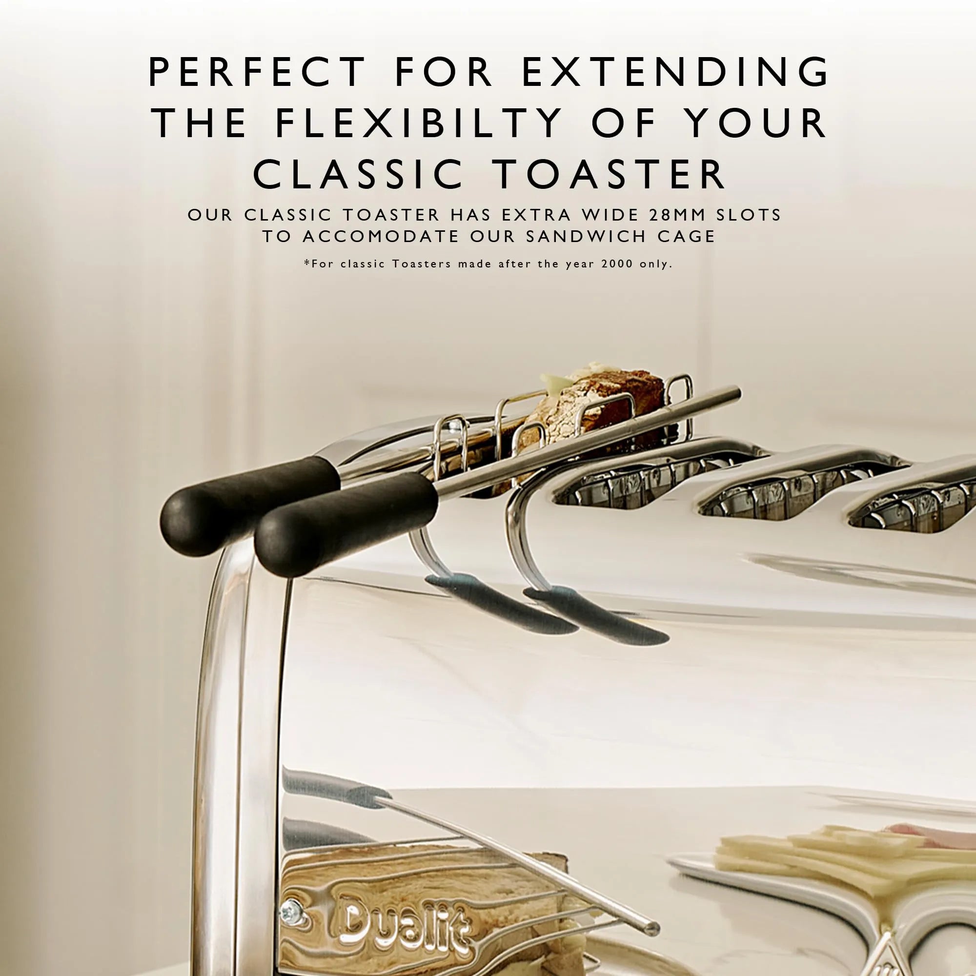 A close-up of a silver toaster with black handles and a clear lid, shown with text at the top reading 'PERFECT FOR EXTENDING THE FLEXIBILITY OF YOUR CLASSIC TOASTER.'.