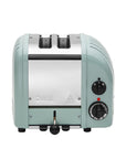 Mint green toaster with black knobs on a white background
