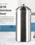Stainless steel coffee press on a marble surface with text about its material and durability.