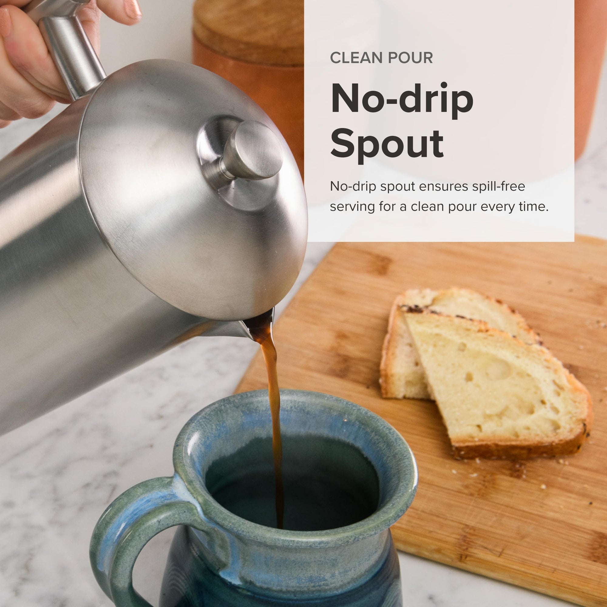 Person pouring coffee from a stainless steel no-drip spout into a blue mug with toast on a wooden board.