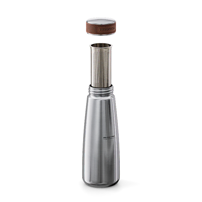 A stainless steel vacuum flask with its lid off, showing a separate metal infuser insert. The flask has a brushed silver finish with a small black logo on the front, and the lid features a brown textured grip.