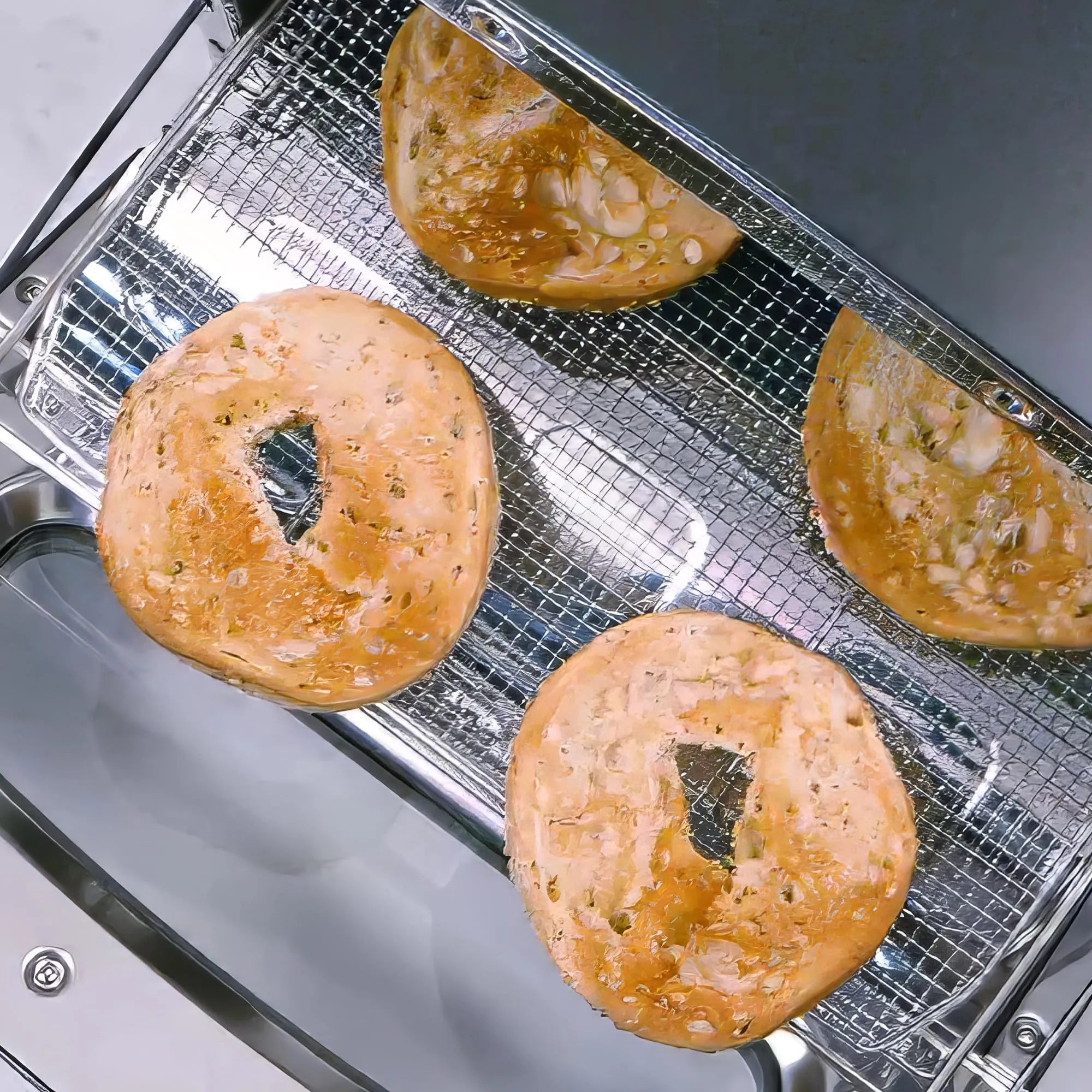 Bagels on a cooling rack inside a toaster oven