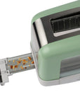 Green toaster with a crumb tray on a white background