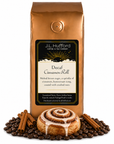 1 lb Decaf Cinnamon Roll coffee beans bag with coffee beans, cinnamon sticks, and cinnamon roll in front displayed on a white background