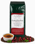 1 lb Cranberry Creme Brulee coffee beans bag with coffee beans, cranberries, and creme brulee in front displayed on a white background