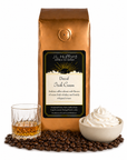 1 lb J.L. Hufford Decaf Irish Cream coffee bag with coffee beans, glass of Irish whiskey, and bowl of whipped cream on a white background
