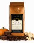 1 lb J.L. Hufford Pumpkin Fudge coffee bag with coffee beans, pumpkin, blocks of fudge, and blocks of white chocolate on a white background