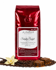 1 lb Simply Sinful coffee beans bag with coffee beans, vanilla, and bar of chocolate drizzled with caramel in front displayed on a white background