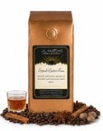 1 lb J.L. Hufford Spiced Butter Rum coffee bag with coffee beans, spices, and glass of rum on a white background
