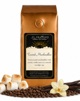 1 lb Toasted Marshmallow coffee beans bag with coffee beans, toasted marshmallows, and vanilla sticks in front displayed on a white background