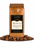 1 lb J.L. Hufford Toffee Praline Crunch coffee bag with coffee beans, praline, and caramel blocks drizzled with chocolate on a white background