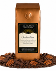 1 lb coffee bag labeled 'Chocolate Pecan' with chocolate pecan flavor, surrounded by coffee beans, chocolate, and pecans on a white background.