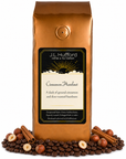 1 lb Cinnamon Hazelnut coffee beans bag with coffee beans, cinnamon sticks, and hazelnuts in front displayed on a white background