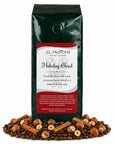 1 lb Holiday Blend coffee beans bag with coffee beans, hazelnuts, and cinnamon sticks in front displayed on a white background